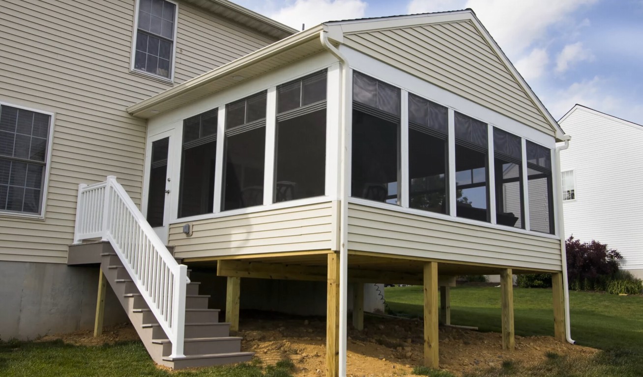 Climate-controlled sunroom with views of nature and comfortable seating